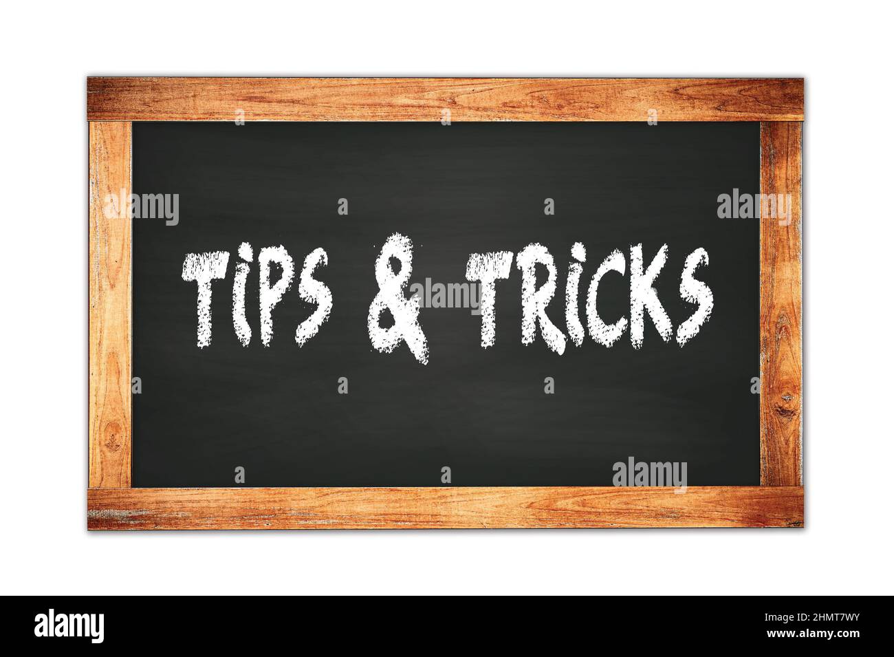 TIPS & TRICKS text written on black wooden frame school blackboard ...