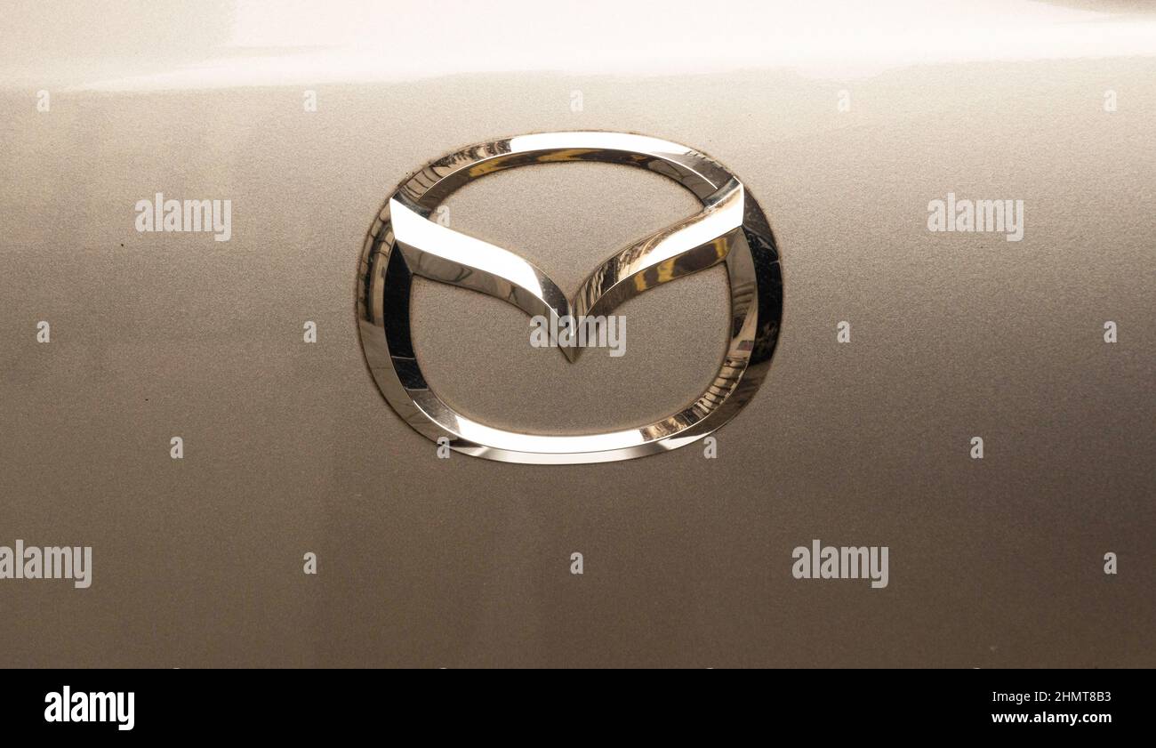 The logo hood ornament on a Mazda2 auto Stock Photo