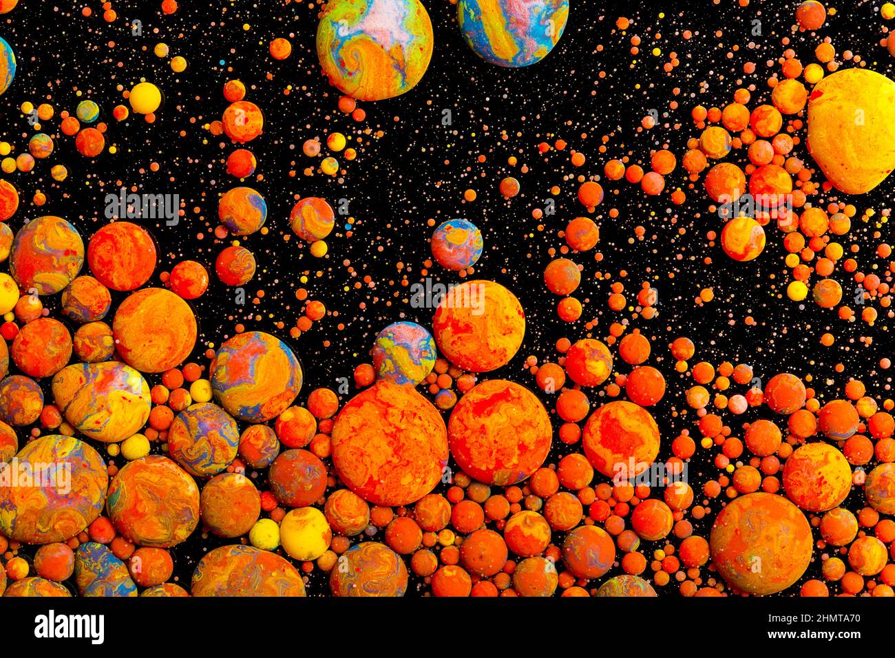 Abstract orange Acrylic ink bullets on black Stock Photo Alamy