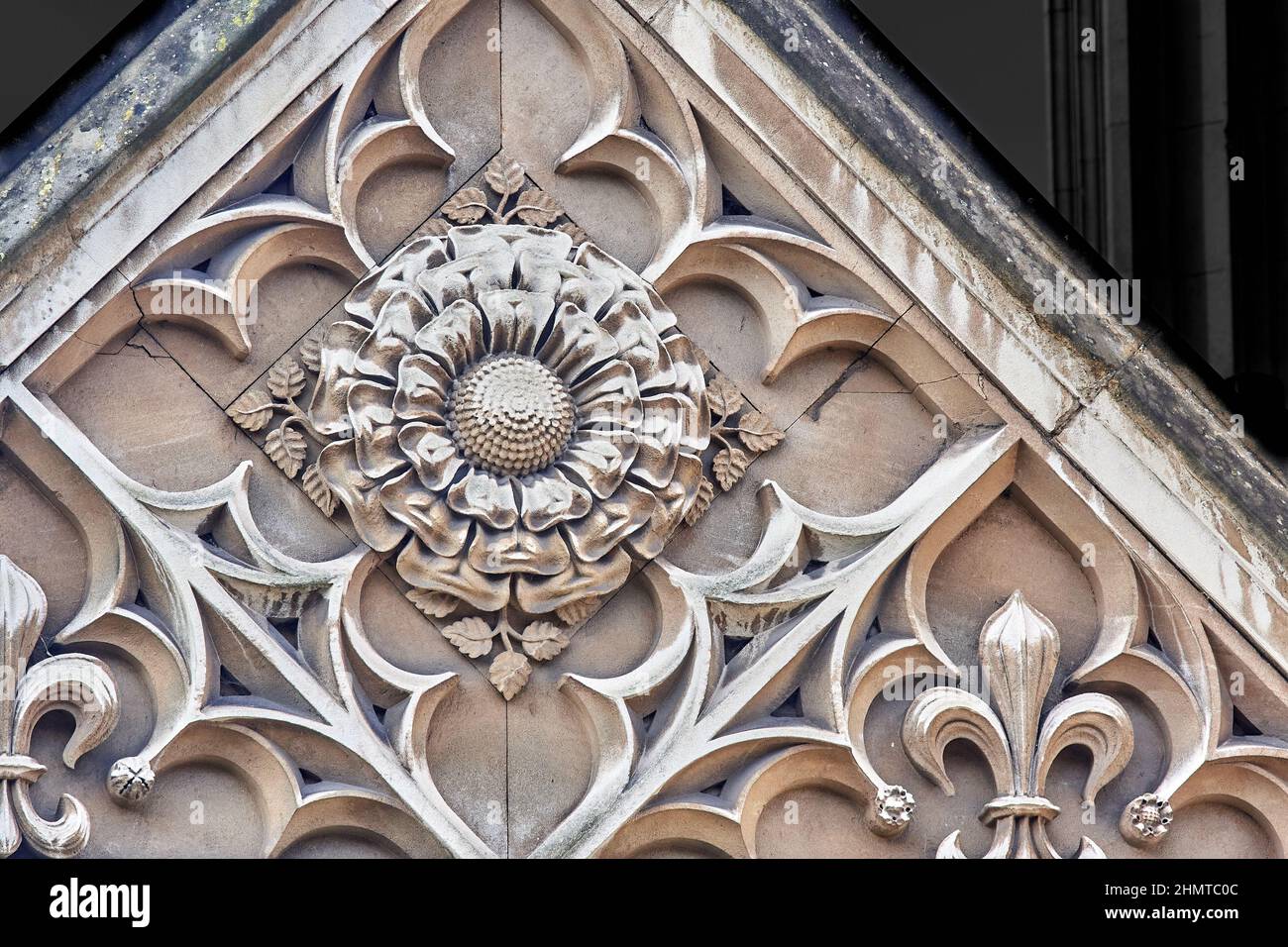 Decorative stone rose, a Tudor symbol, on outside wall of King's college, university of Cambridge, England. Stock Photo