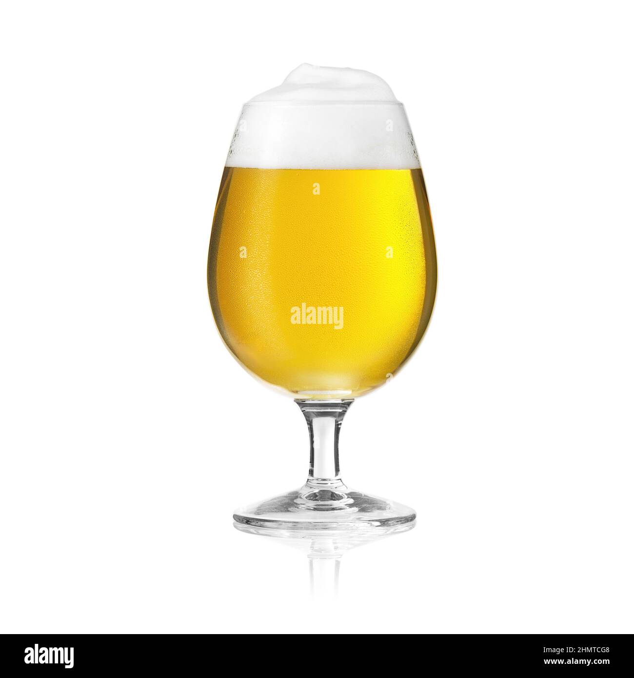 Golden beer glass pilsner beer tulip with foam crown and dew condensing water drops Stock Photo