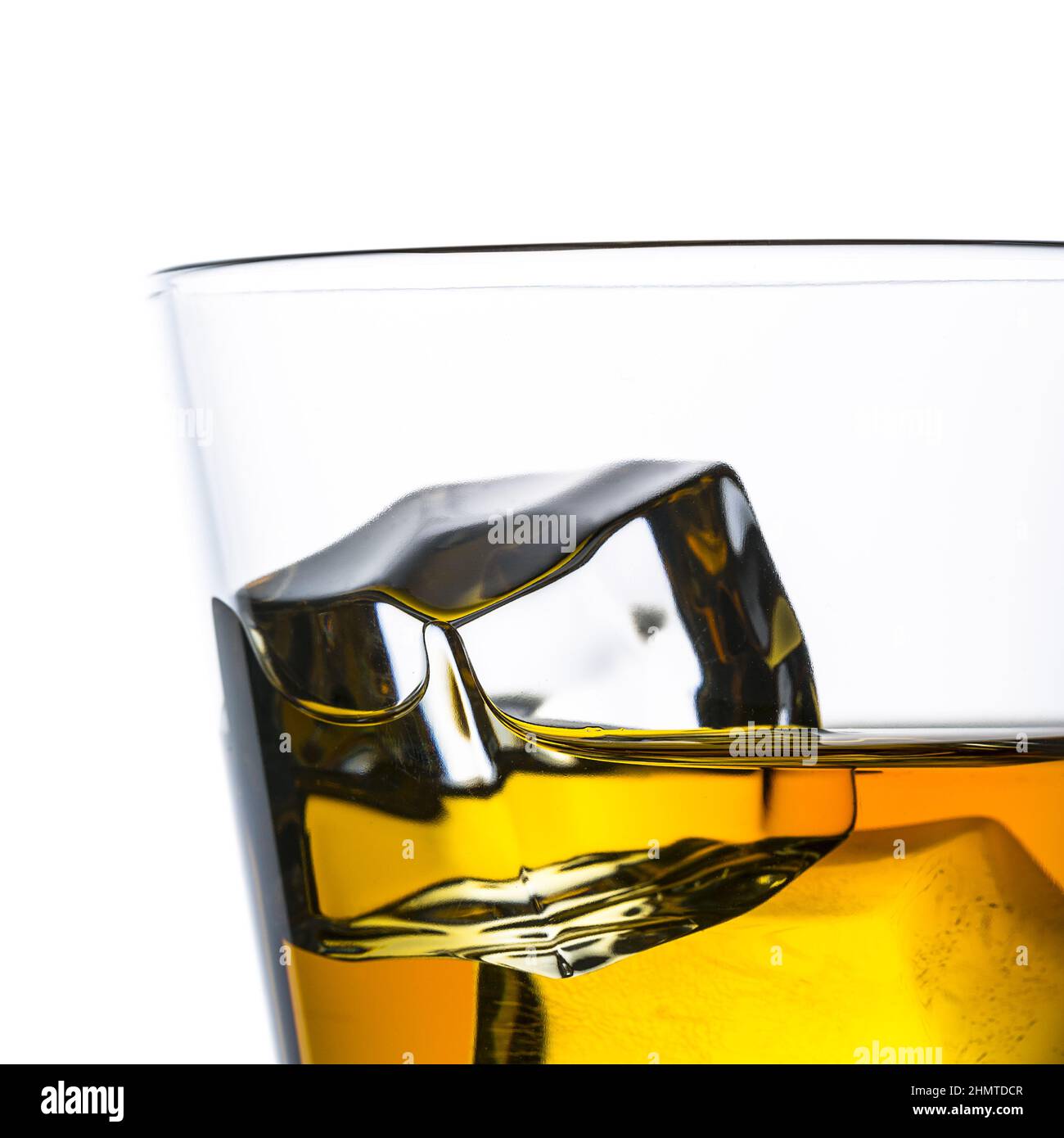 A glass of whiskey with ice cubes on white background. Taken in Studio