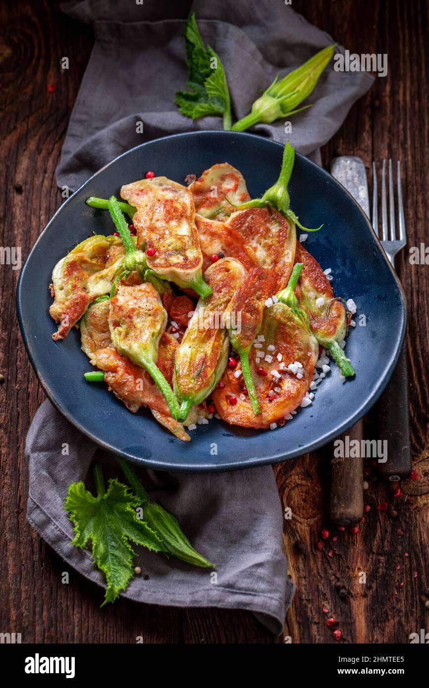 Homemade fried zucchini flower as unique summer vegetarian snack