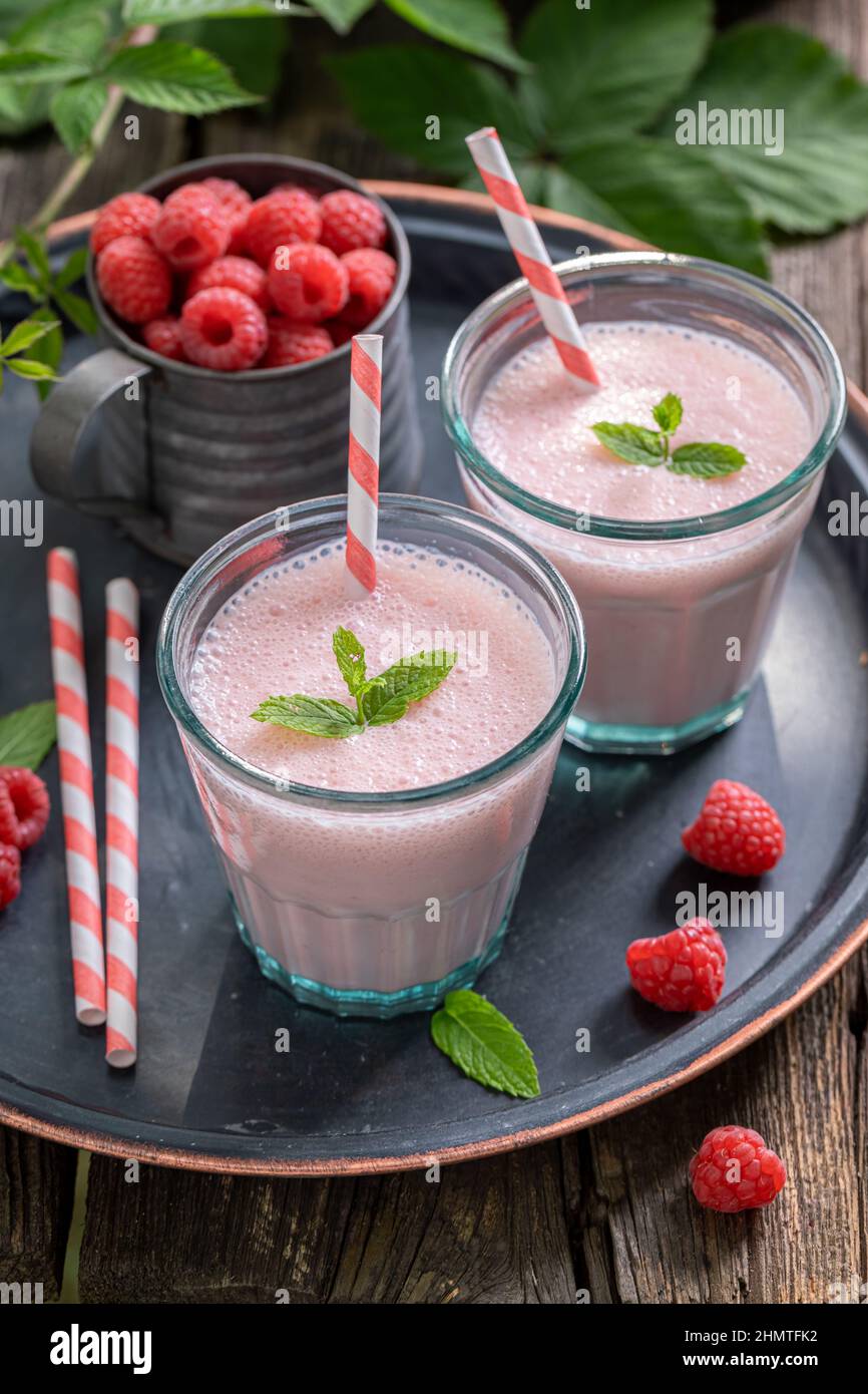 Healthy cocktail with seasonal fruit and milk. Fresh raspberry smoothie