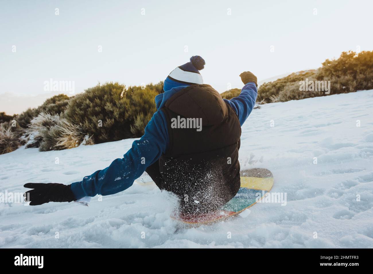young man skiing with a board on the snow. Stock Photo