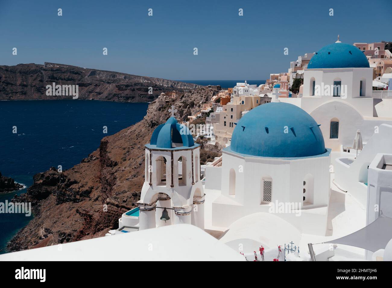 View of Oia town with church and blue dome in Santorini island in Greece. Summer vacation and holiday concept, luxury travel. Wonderful scenery, cruis Stock Photo