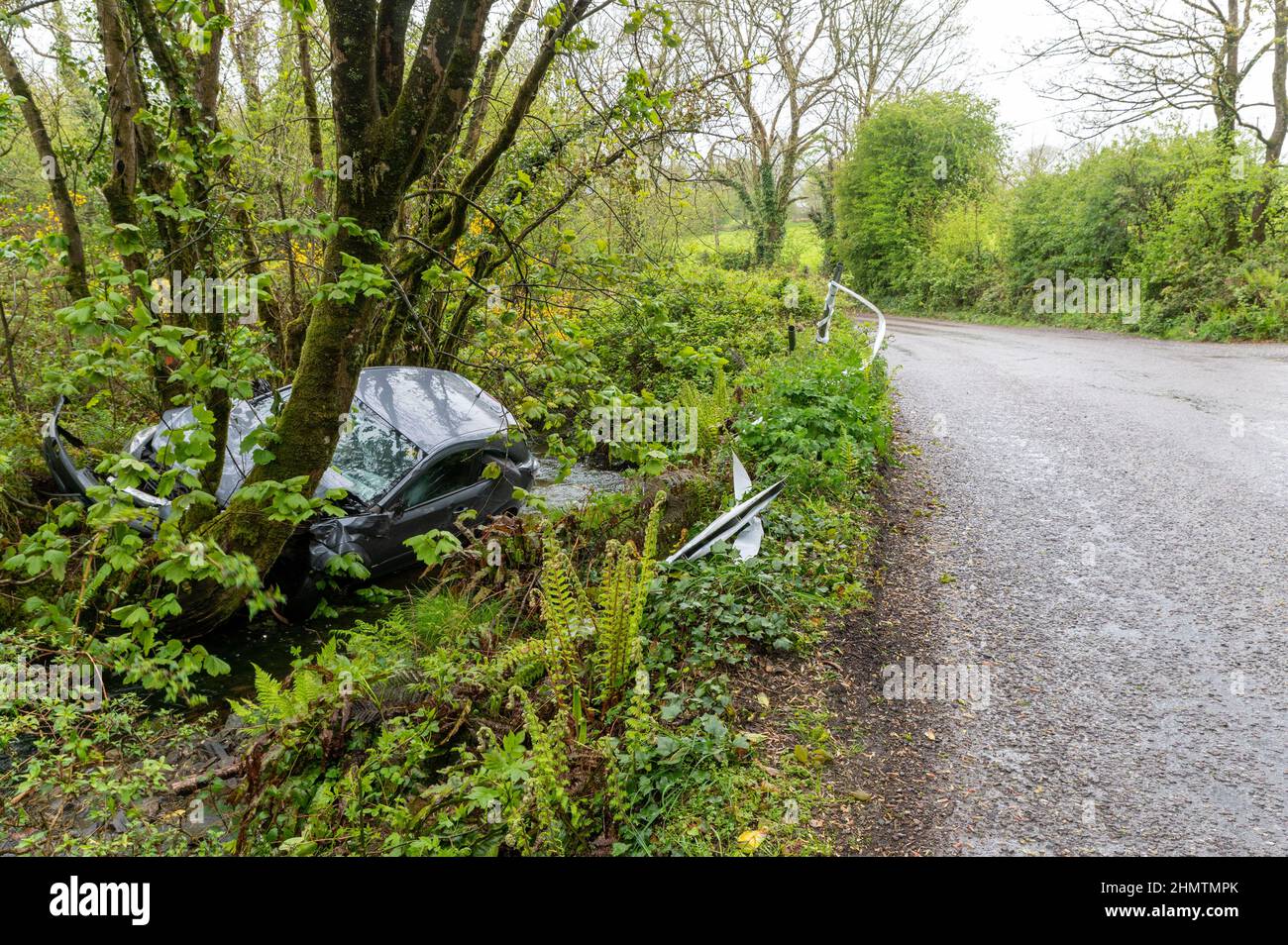 Car in ditch near Ballinspittle, Co. Cork Picture. John Allen Stock Photo