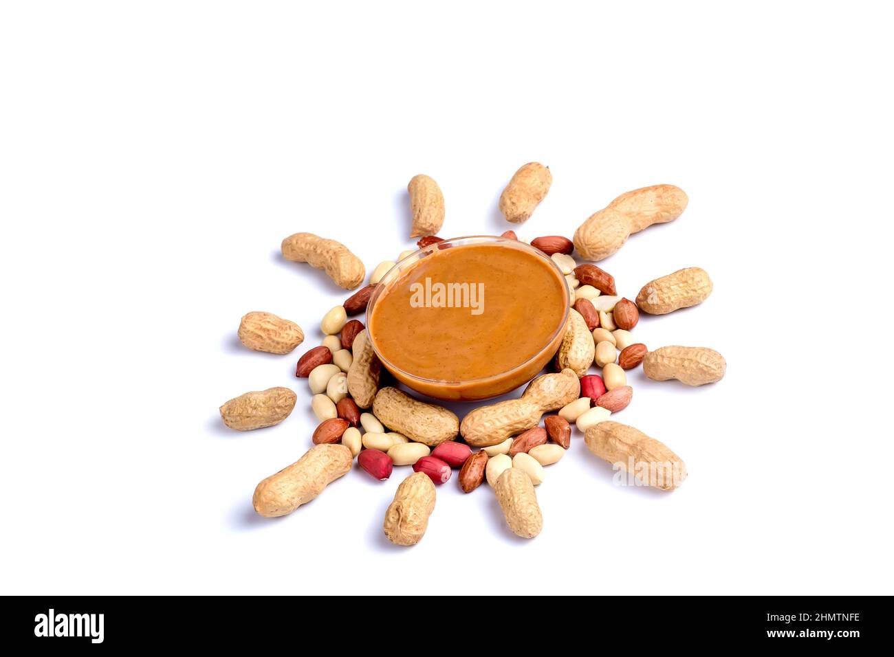 Peanut butter isolated and peanuts in the peel scattered on the white