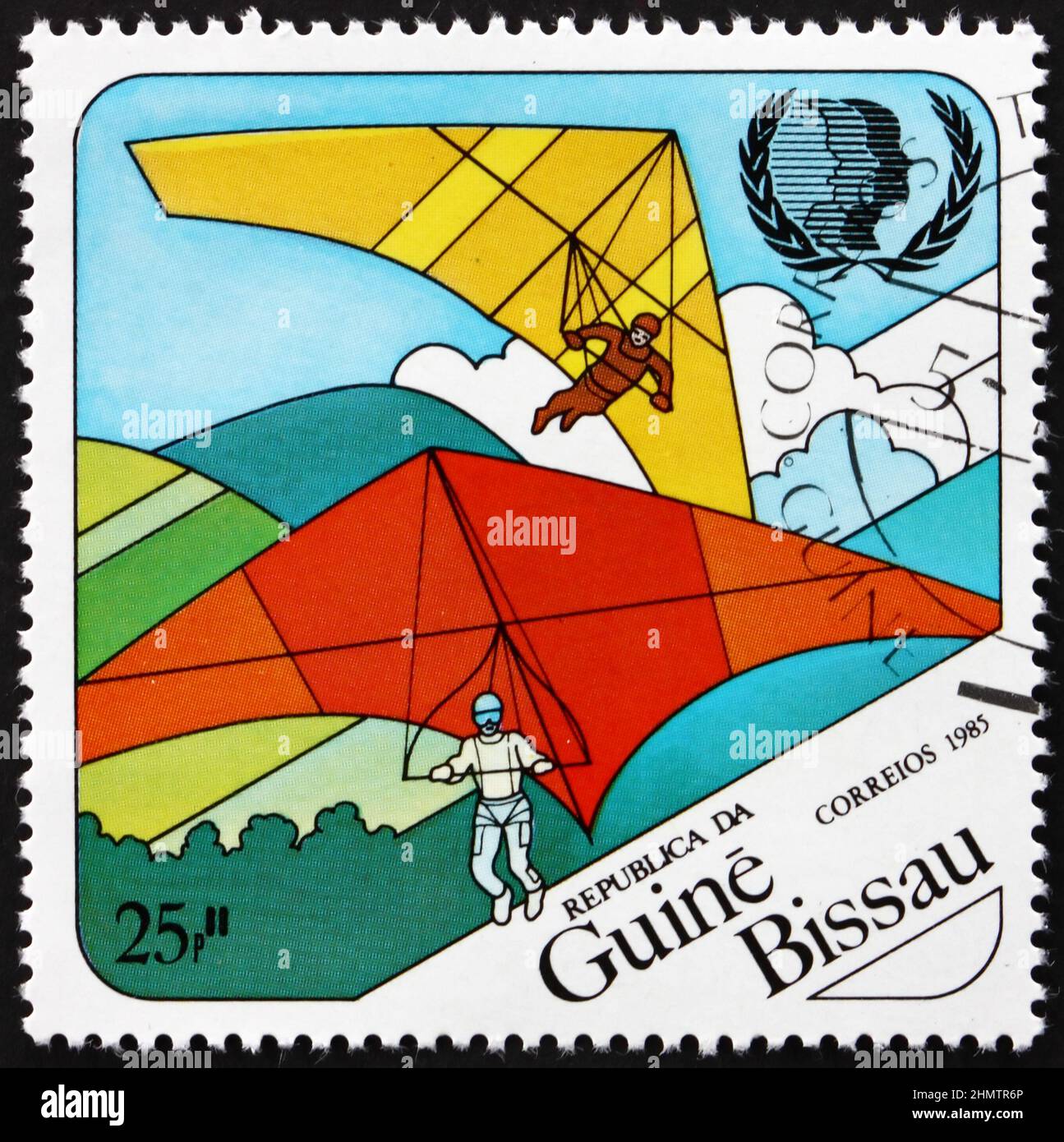 GUINEA-BISSAU - CIRCA 1985: a stamp printed in Guinea-Bissau shows hang gliding, International Youth Year, circa 1985 Stock Photo