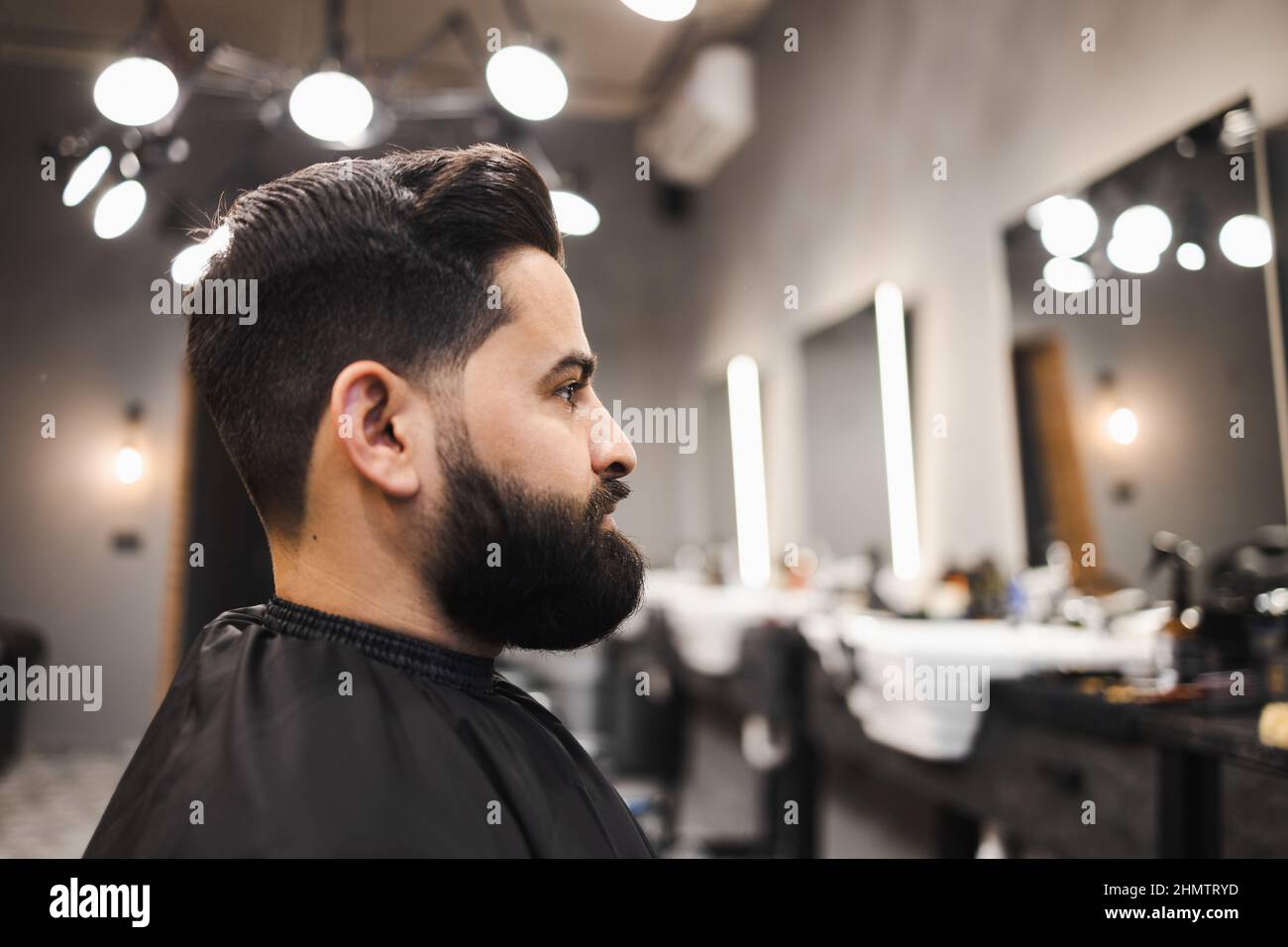 bearded-man-sitting-on-barbershop-chair-stock-photo-alamy