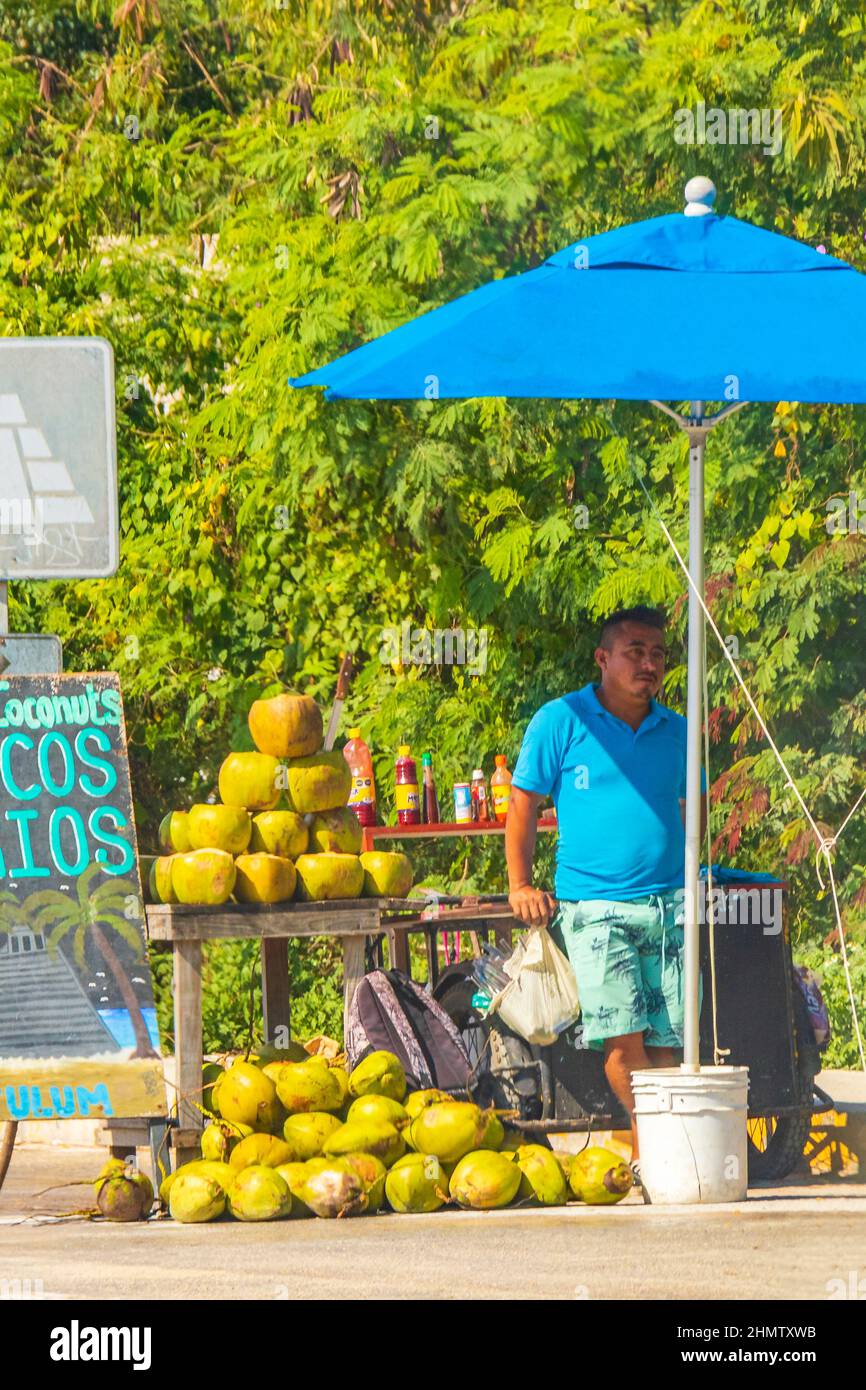 Tulum Mexico 02. February 2022 Street food fruits coconuts and drinks on typical street road and cityscape in Tulum in Mexico. Stock Photo