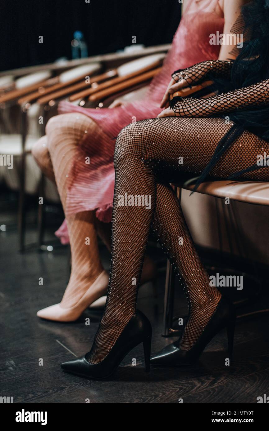 Female slender legs in elegant mesh tights and black high heel shoes Stock Photo