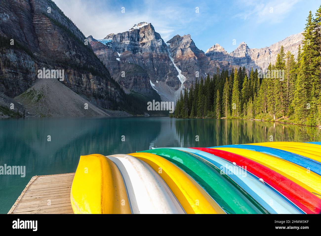 Canoes rest on the dock at Lake Moraine in the morning in canada Stock Photo