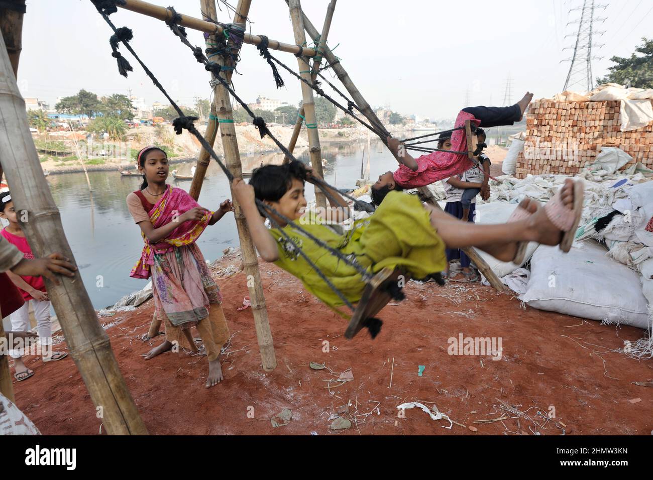 Dhaka, Bangladesh - February 08, 2022: It goes without saying that there is no place for children to play in Dhaka City, so they are playing with bamb Stock Photo