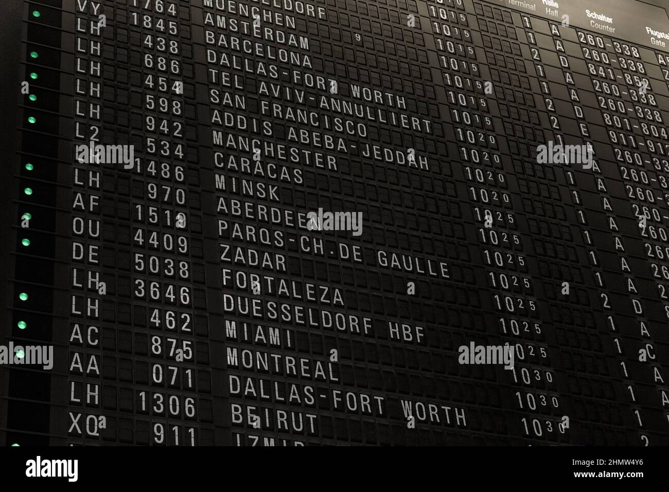 Flights timetable in airport terminal, some flights are delayed, traveling around the world by airplane, time schedule with gate and check-in number Stock Photo