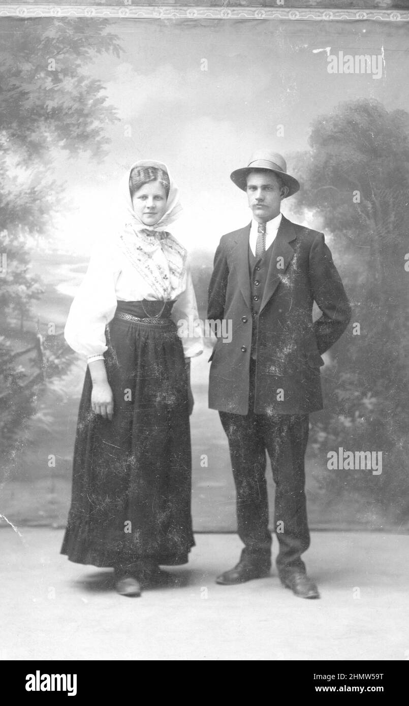 Early 20th century authentic vintage photograph of young couple standing in front of rural backdrop, Sweden. Concept of relationship, togetherness Stock Photo