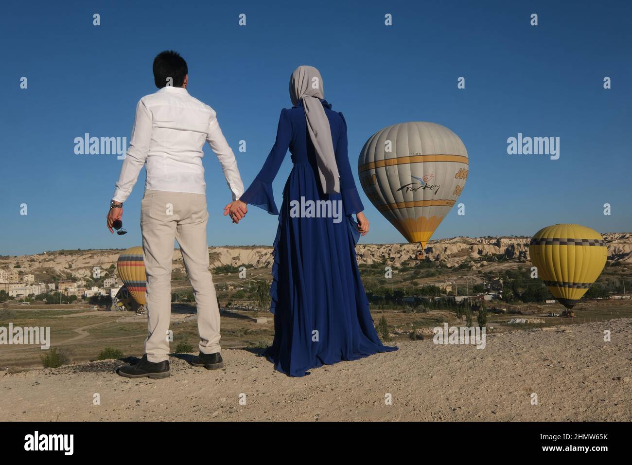 Couple travels the world. Happy and loving couple among balloons in Turkey. Married couple on vacation. Tourists in Cappadocia. Man and woman resting Stock Photo