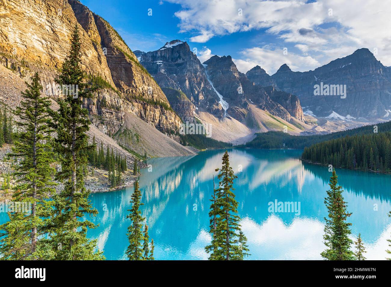 Beautiful turquoise waters of the Moraine lake with snow-covered rocky mountains in Banff National Park of Canada panorma Stock Photo