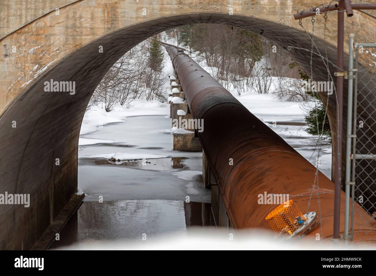Au Train, Michigan - A hydroelectric power project operated by Renewable World Energies. A pipe carries water from the Forest Lake Dam to a power plan Stock Photo
