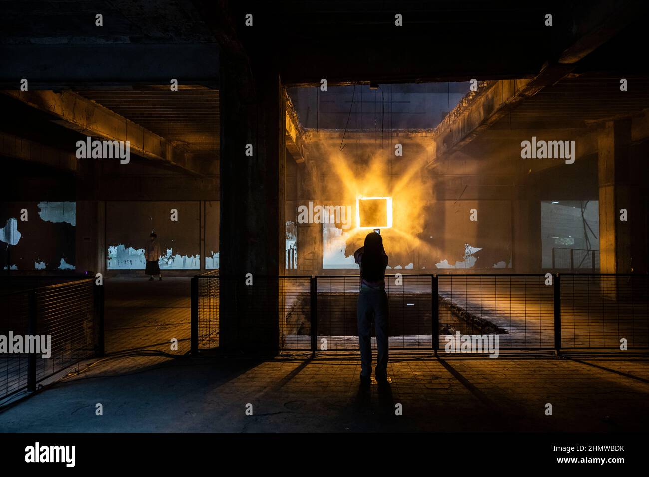 Bangkok, Thailand. 12th Feb, 2022. A woman takes a photo of a hanging art installation in an abandoned mall during Bangkok Design Week in Bangkok, Thailand, February 12, 2022. (Credit Image: © Andre Malerba/ZUMA Press Wire) Credit: ZUMA Press, Inc./Alamy Live News Stock Photo