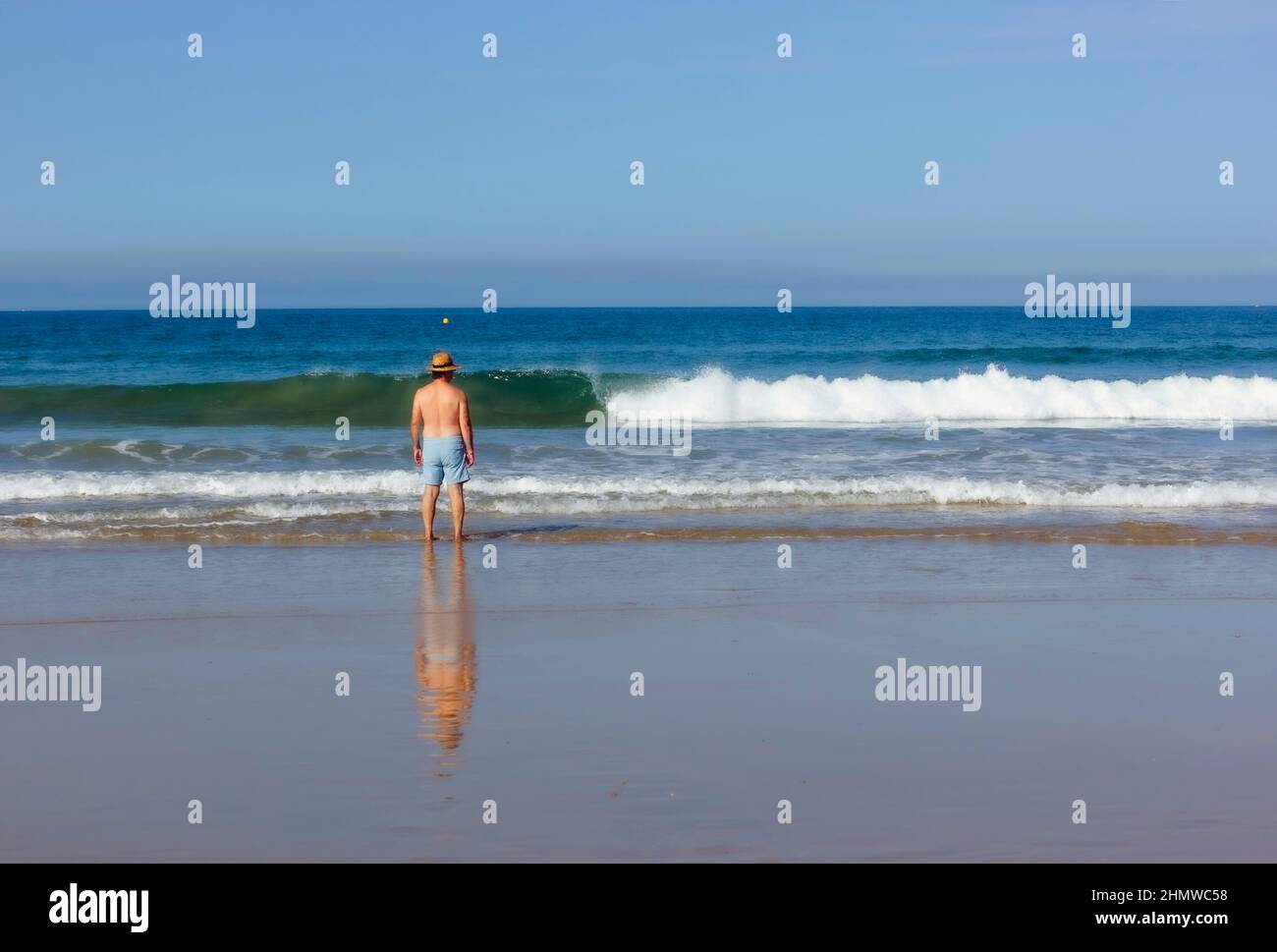 Solitary man looking out to sea Stock Photo