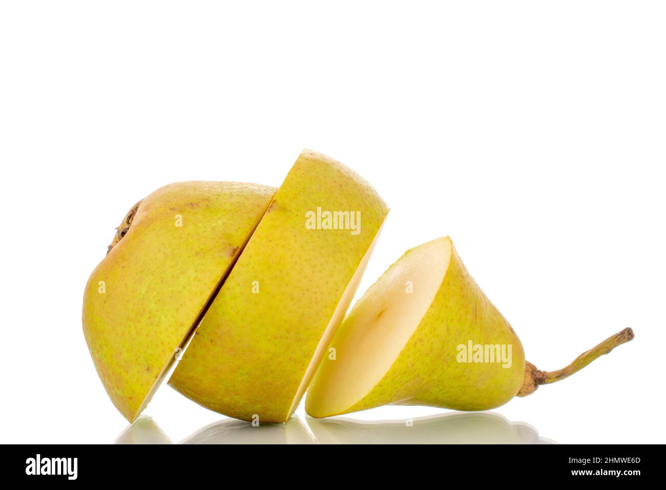One sweet juicy pear cut into three pieces, macro, isolated on a white background. Stock Photo