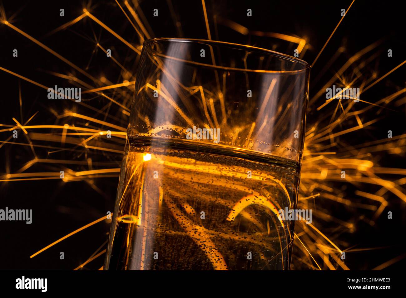 firework behind a champagne glass Stock Photo Alamy