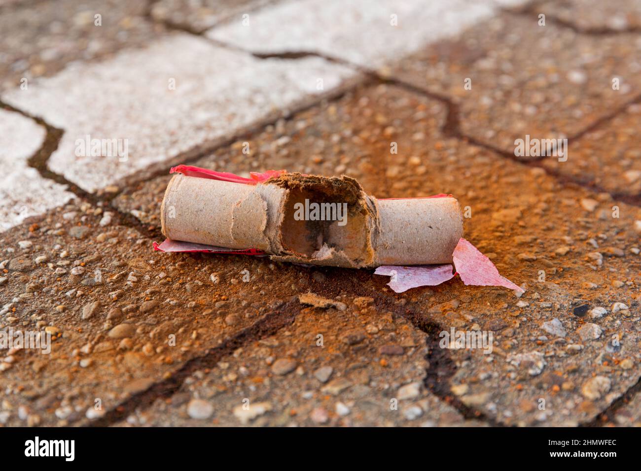 Scattered firecracker are spread on the ground. Stock Photo