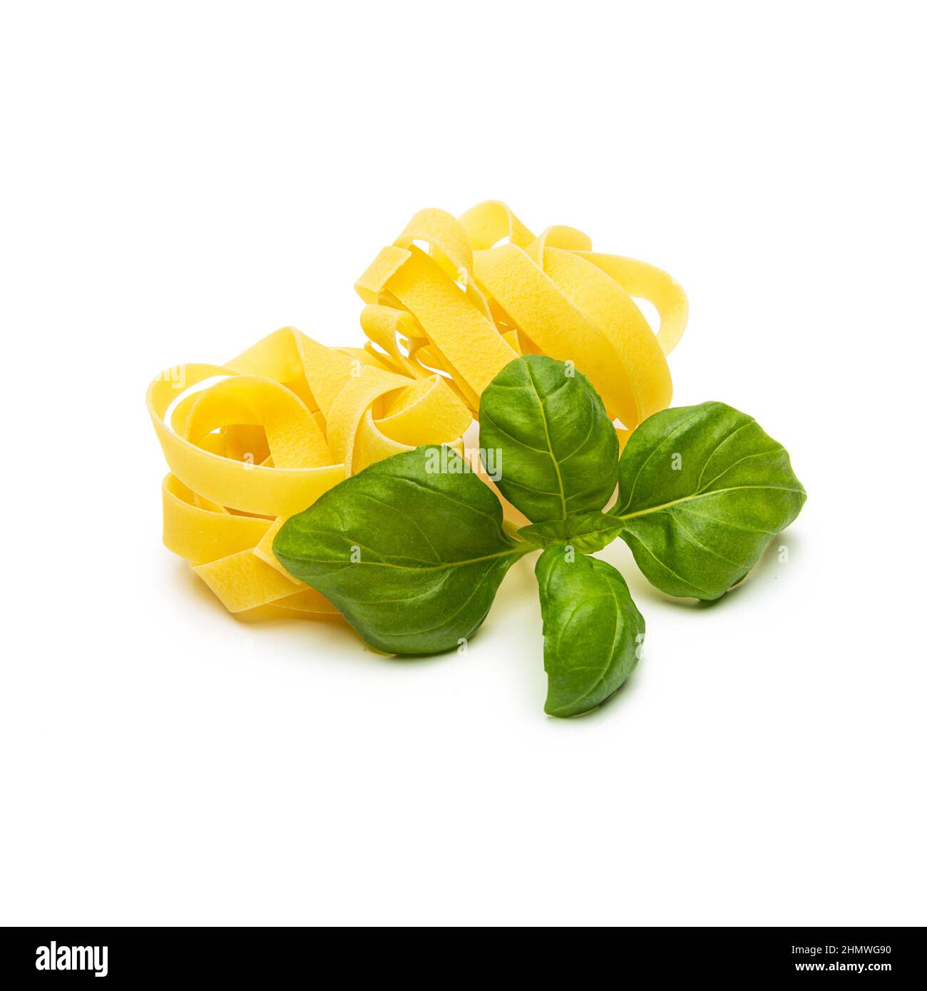 pasta noddle nests with basil leaf Stock Photo
