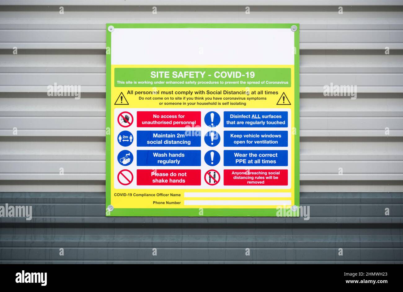 Construction site health and safety message rules sign board signage on fence boundary Stock