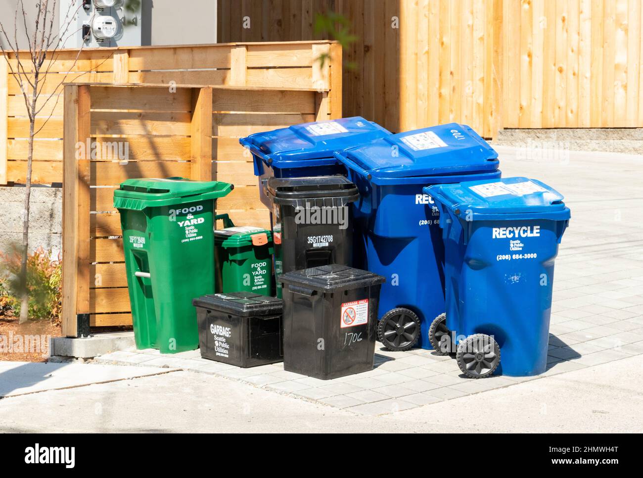 blue black and green recycling sorting refuse trash bins seattle