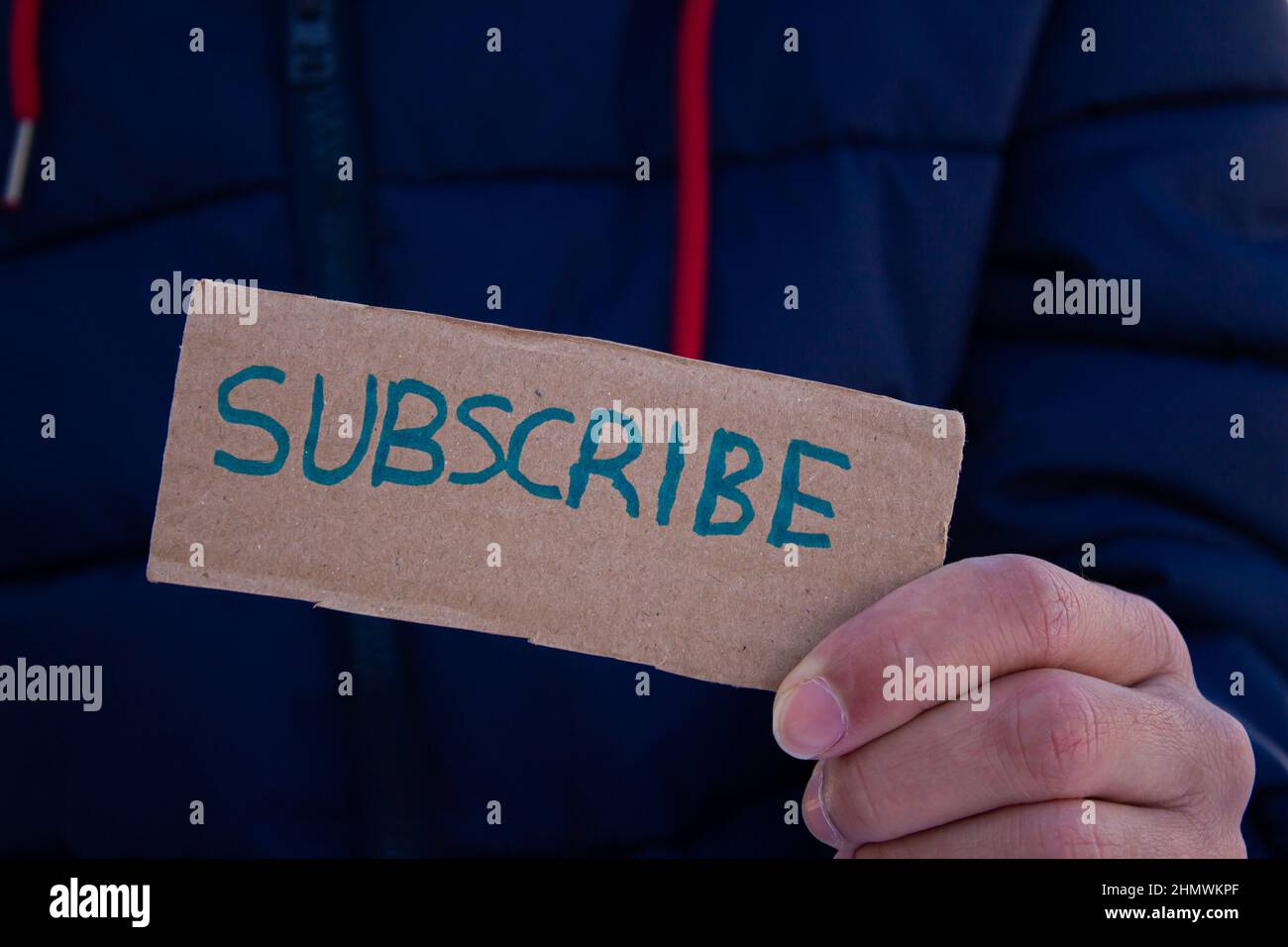 Man holding cardboard box with subscribe word. Stock Photo