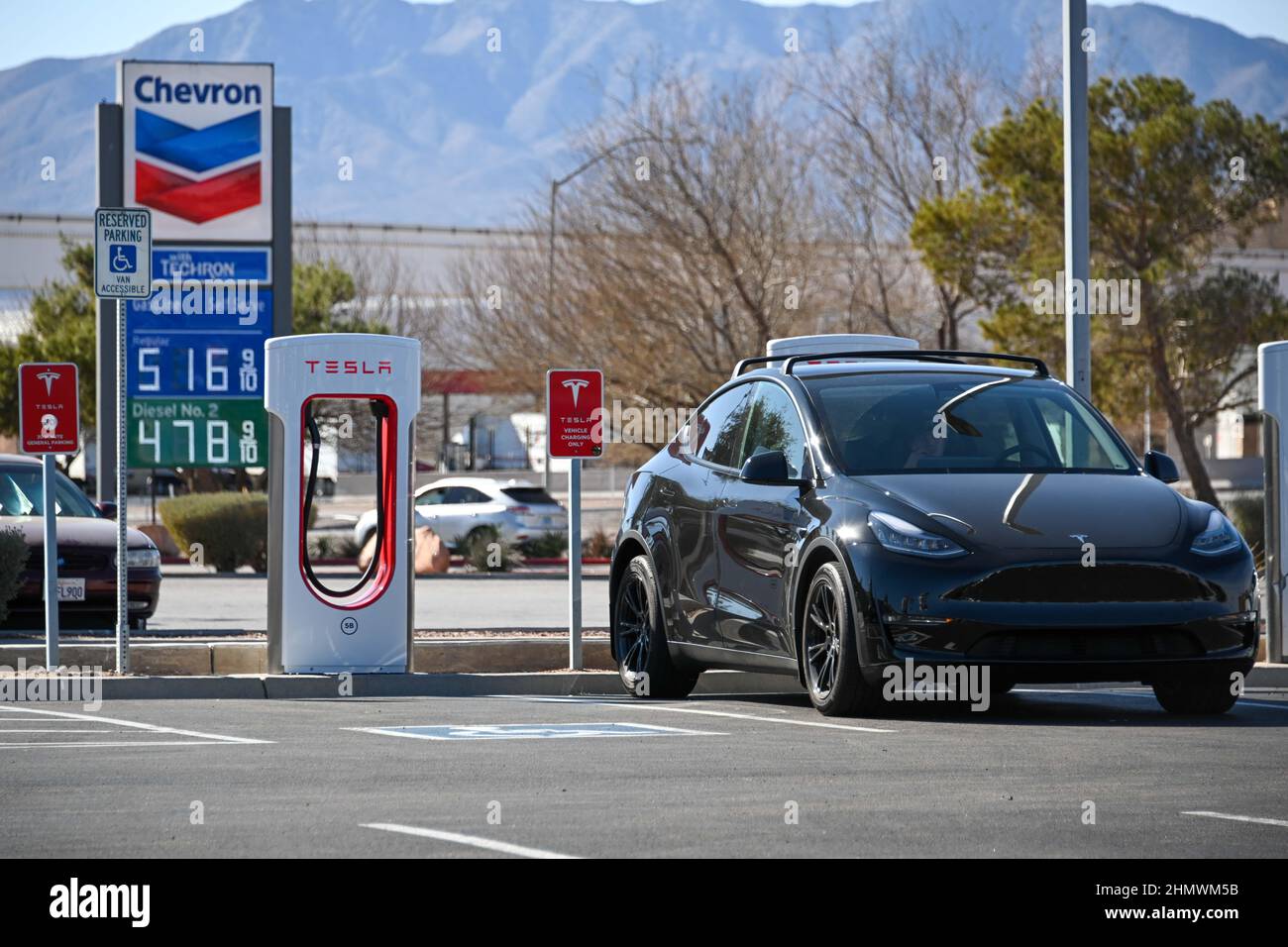 Tesla Model Y cars are seen charging at Tesla Super Chargers with high