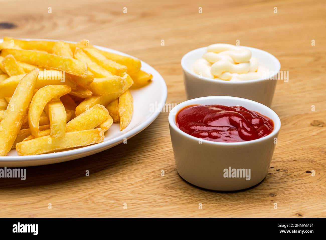 A plate with french fries and ketchup and mayonnaise sauces on wood  background. Taken in Studio with a 5D mark III Stock Photo - Alamy