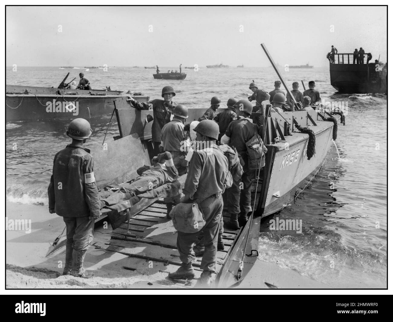 1944 WW2 St. Tropez wounded US soldiers are loaded onto a LCVP for transfer to hospital ship Invasion troops of U.S. Army establishes a beachhead in Saint-Tropez, France during World War II.  Wounded U.S. soldiers are placed aboard LCVPs (Landing Craft, Vehicle, Personnel)            South of France 1944 World War II Second World War Stock Photo
