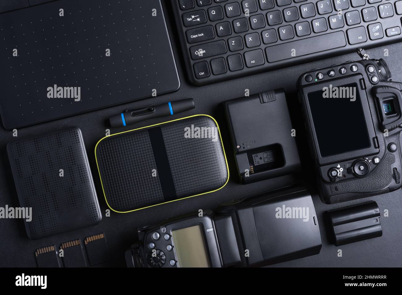 Top view of photographer work space with digital camera, flash, memory