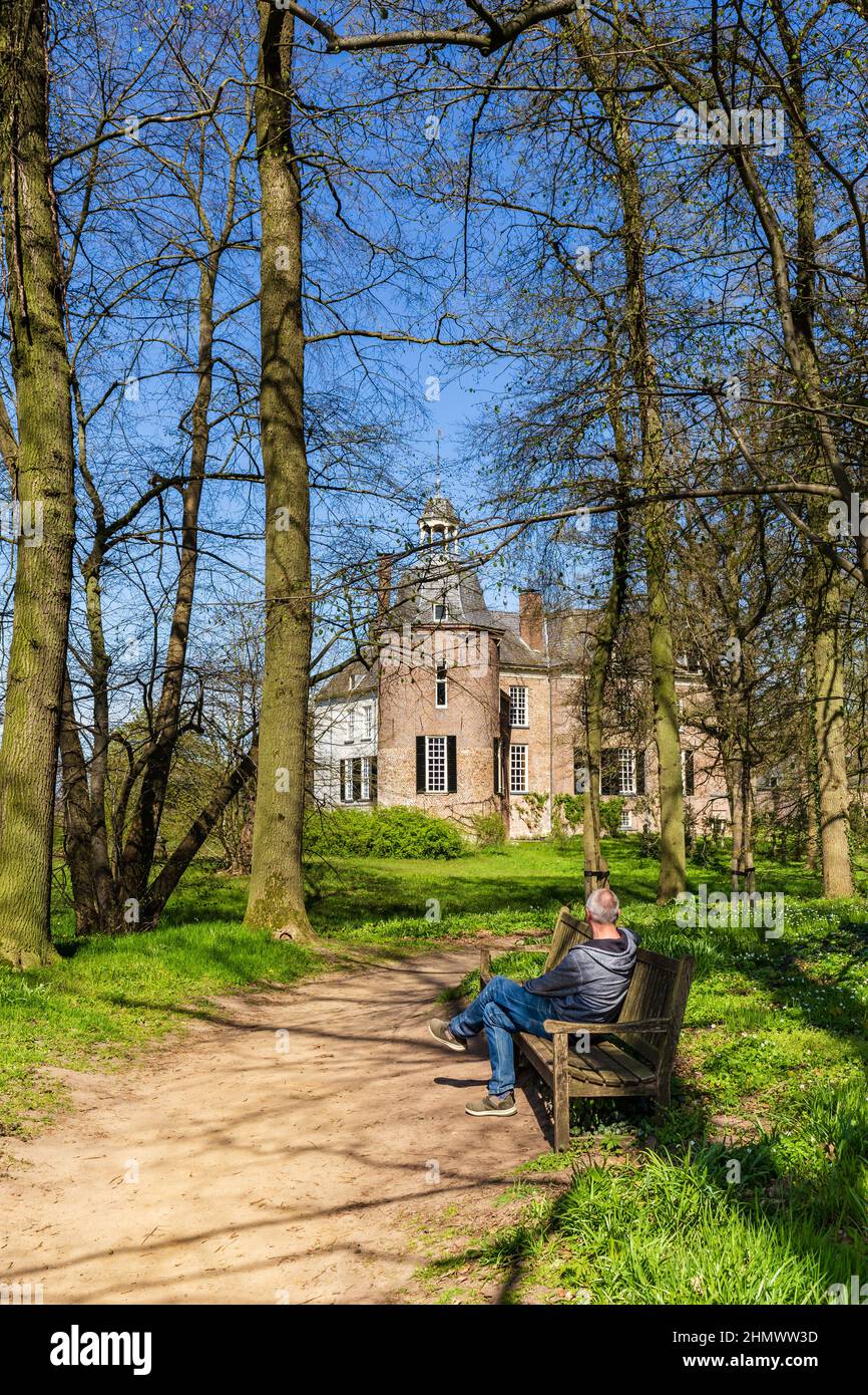 Vorden, The Netherlands - April 26, 2021: Man enjoying the view looking at astle and park Hackfort in Vorden Gelderland in The Netherlands famous for his beautiful wild flowers Stock Photo