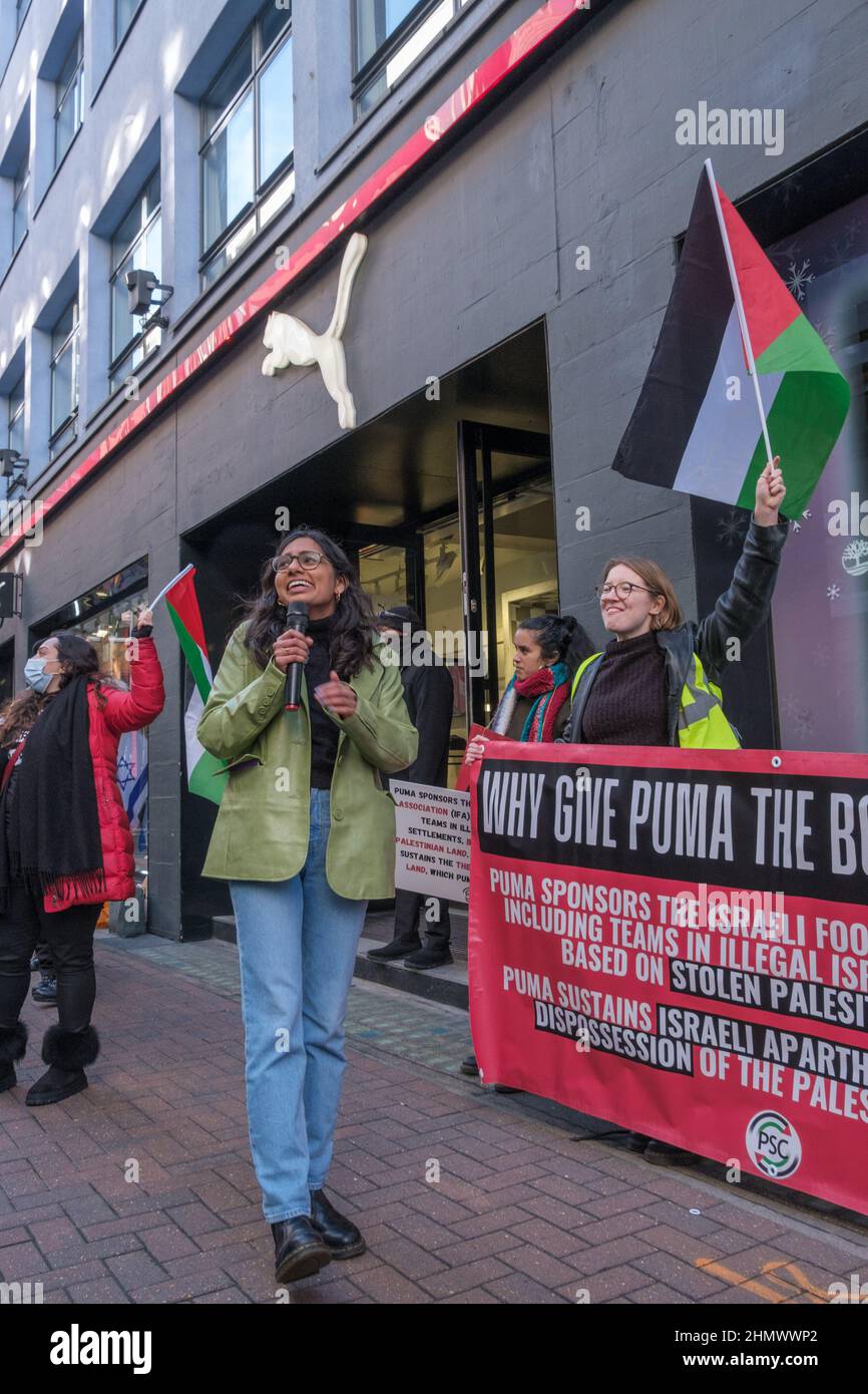 London, UK. 12th Feb 2022. Protesters at Puma's flagship Carnaby St store support over 200 Palestinian sports teams who demand that PUMA end its sponsorship of the Israeli Football Association which includes teams in illegal Israeli settlements on stolen Palestinian land. The protest, part of a day of over 25 similar UK actions by the Palestinian Solidarity Campaign UK, was opposed by a small group with Israel flags who shouted at them. Peter Marshall/Alamy Live News Stock Photo