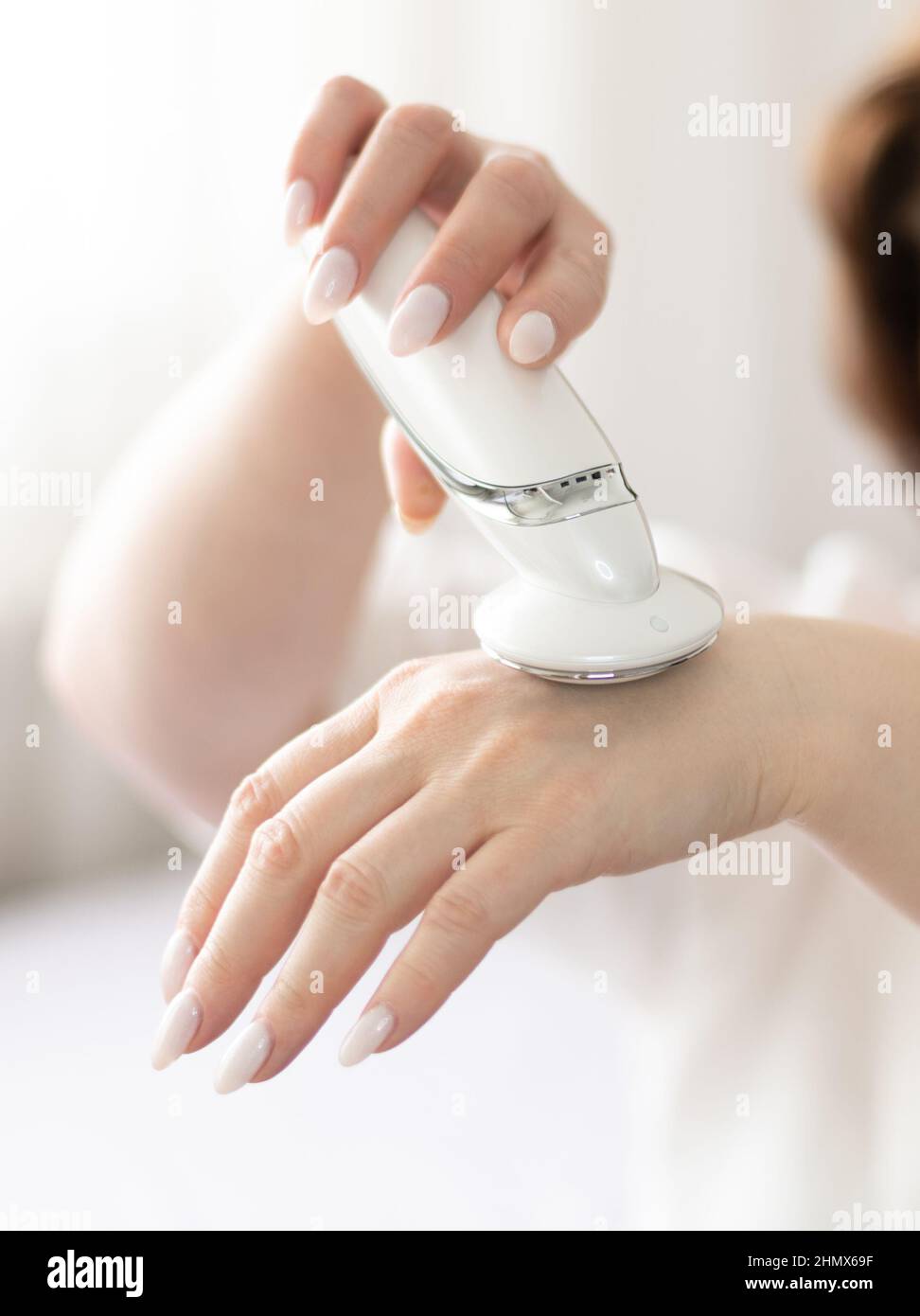 Hardware cosmetology of the skin of the hands independently at home Stock Photo