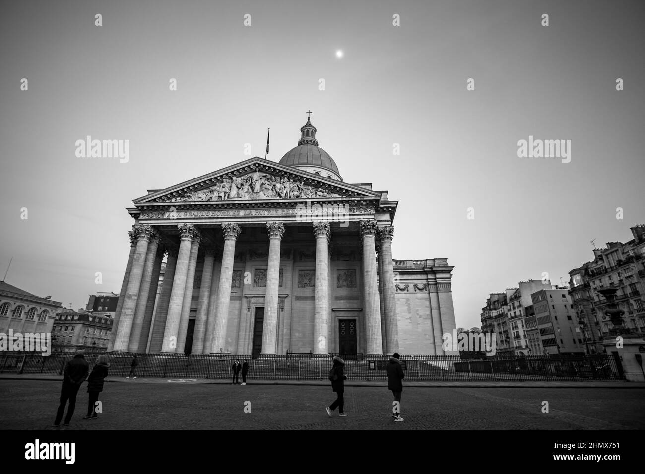 Paris, France - February 11, 2022 : The famous Pantheon of Paris and tourist walking by in black and white Stock Photo