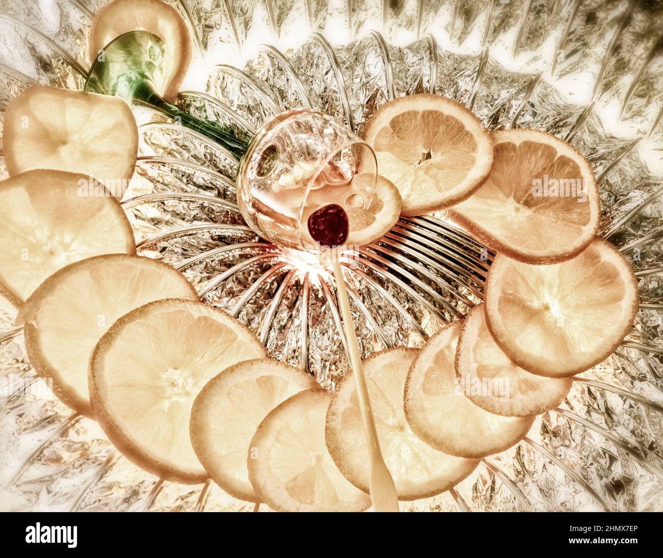 Abstract food still-life of Orange slices, and single cherry, arranged in a spiral and backlit Stock Photo