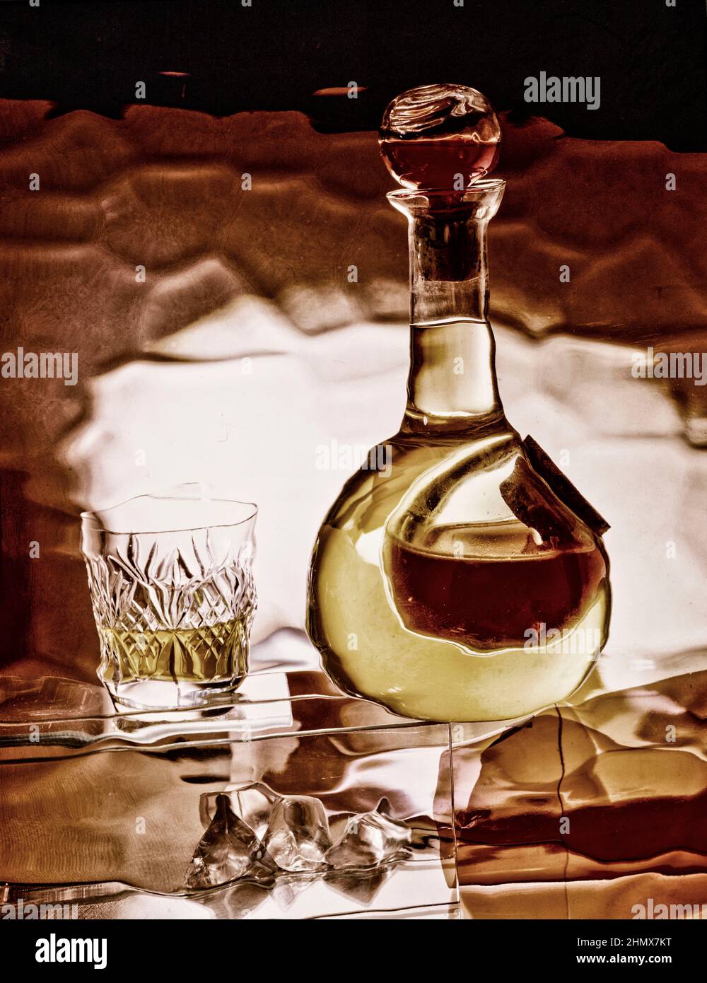 Creative abstract still-life of glass bottle with colour, and a cut crystal glass Stock Photo