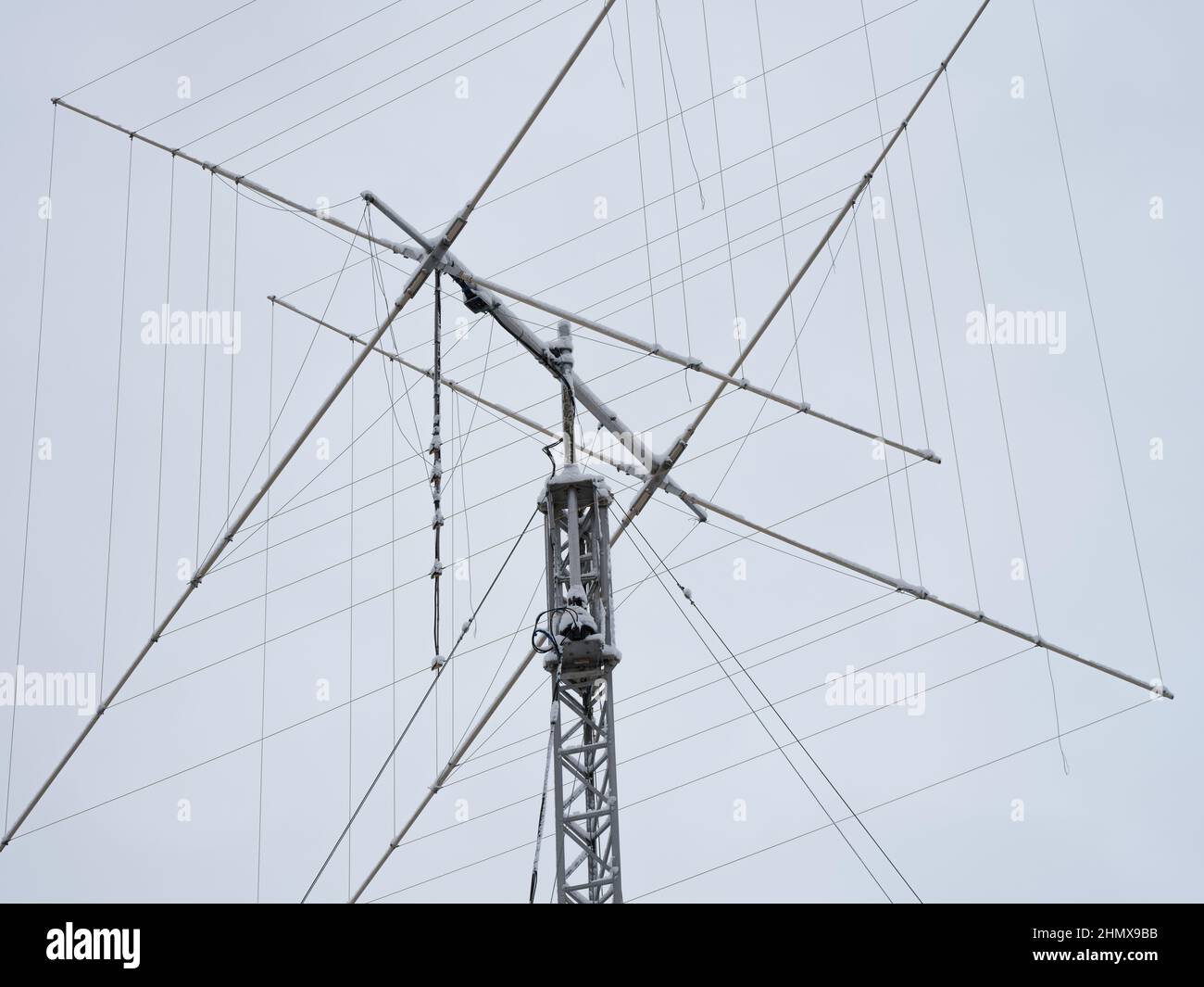 A tall ham radio antenna with some snow on it. Close up. Stock Photo