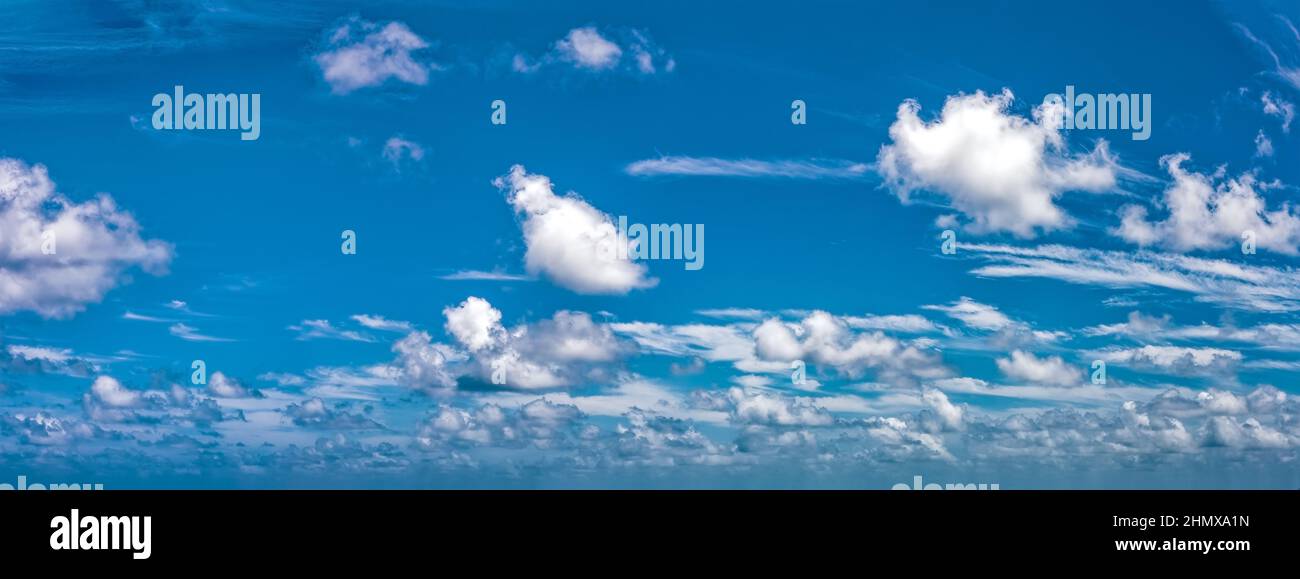 High resolution Panoramic background with blue day time sky and white clouds. Copy space. Stock Photo