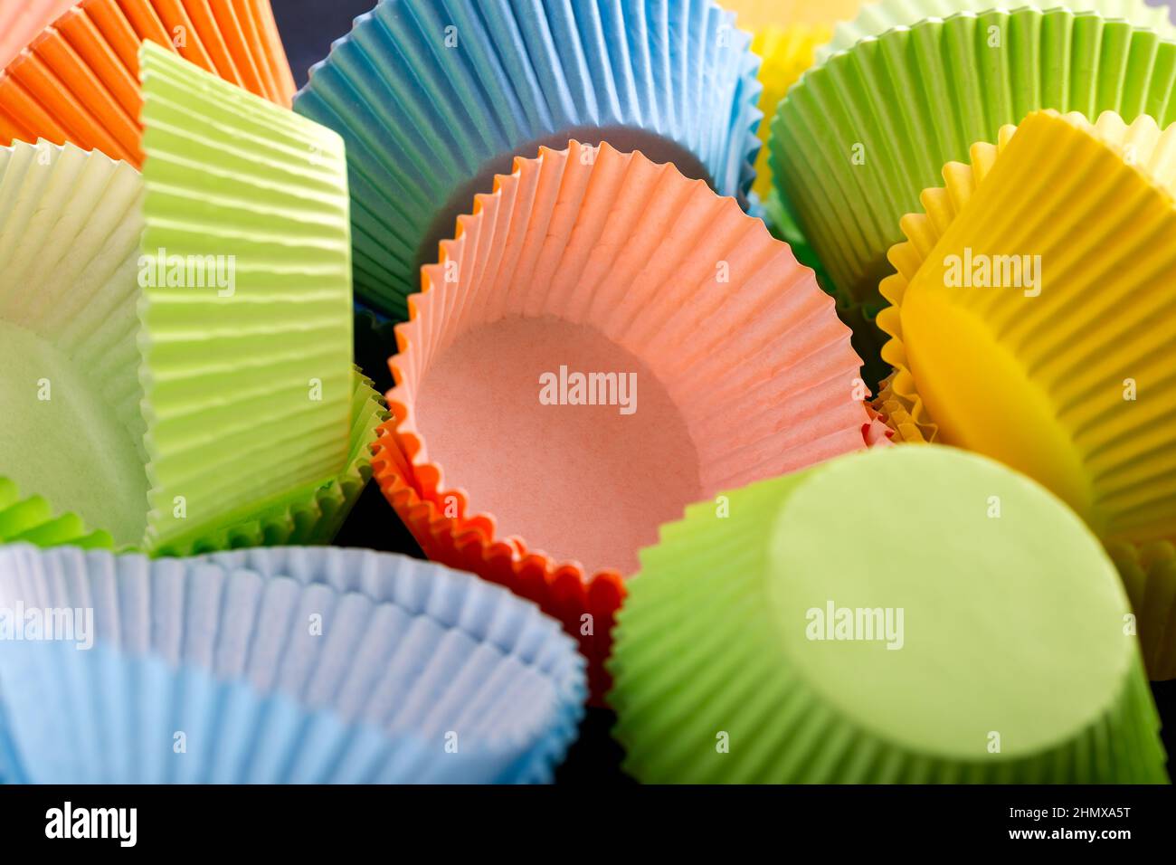 Empty cupcake cases, forms on blue background, table Stock Photo Alamy