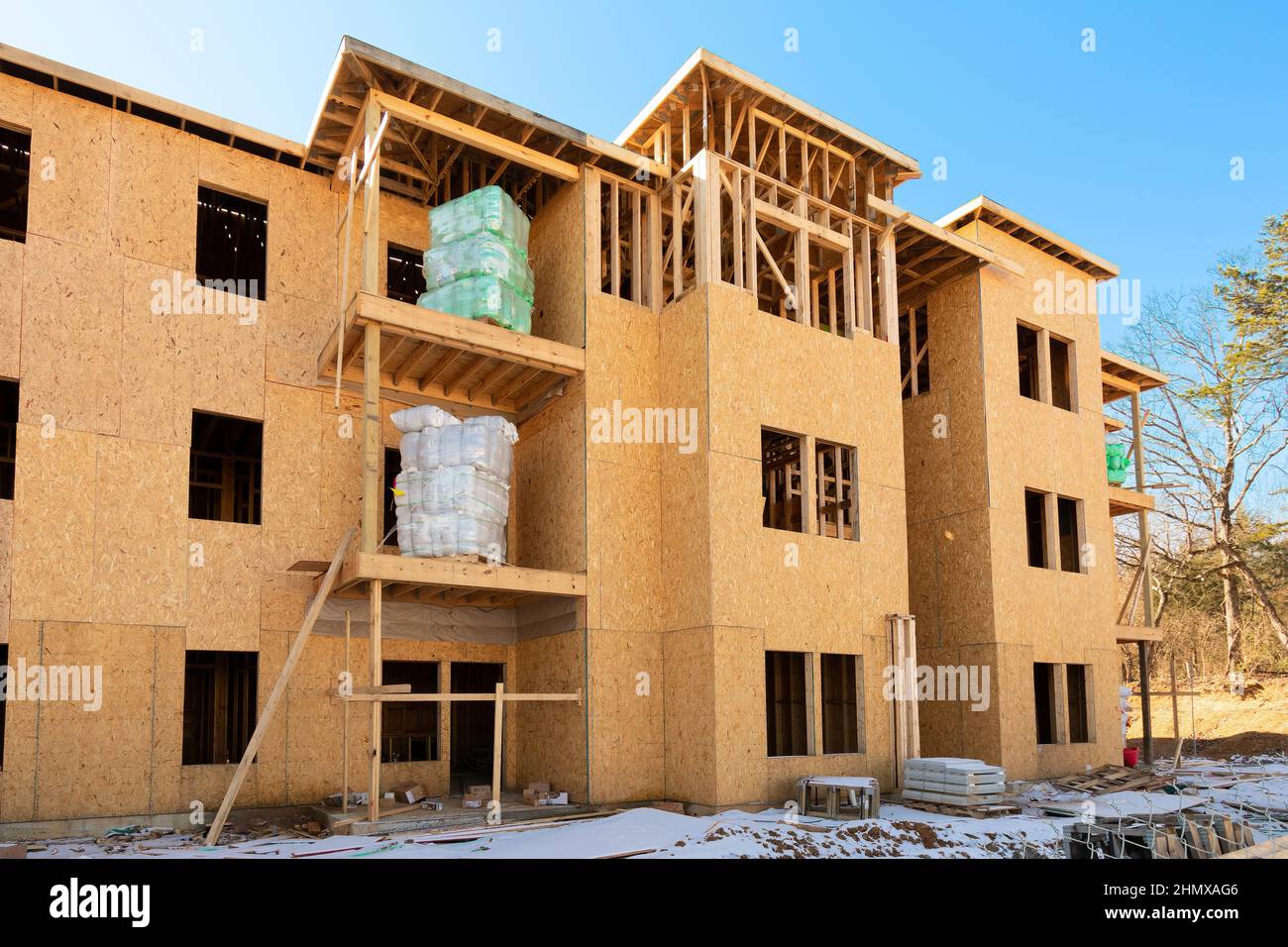 Horizontal shot of rolls of insulation await installation in a new apartment complex under construction. Stock Photo
