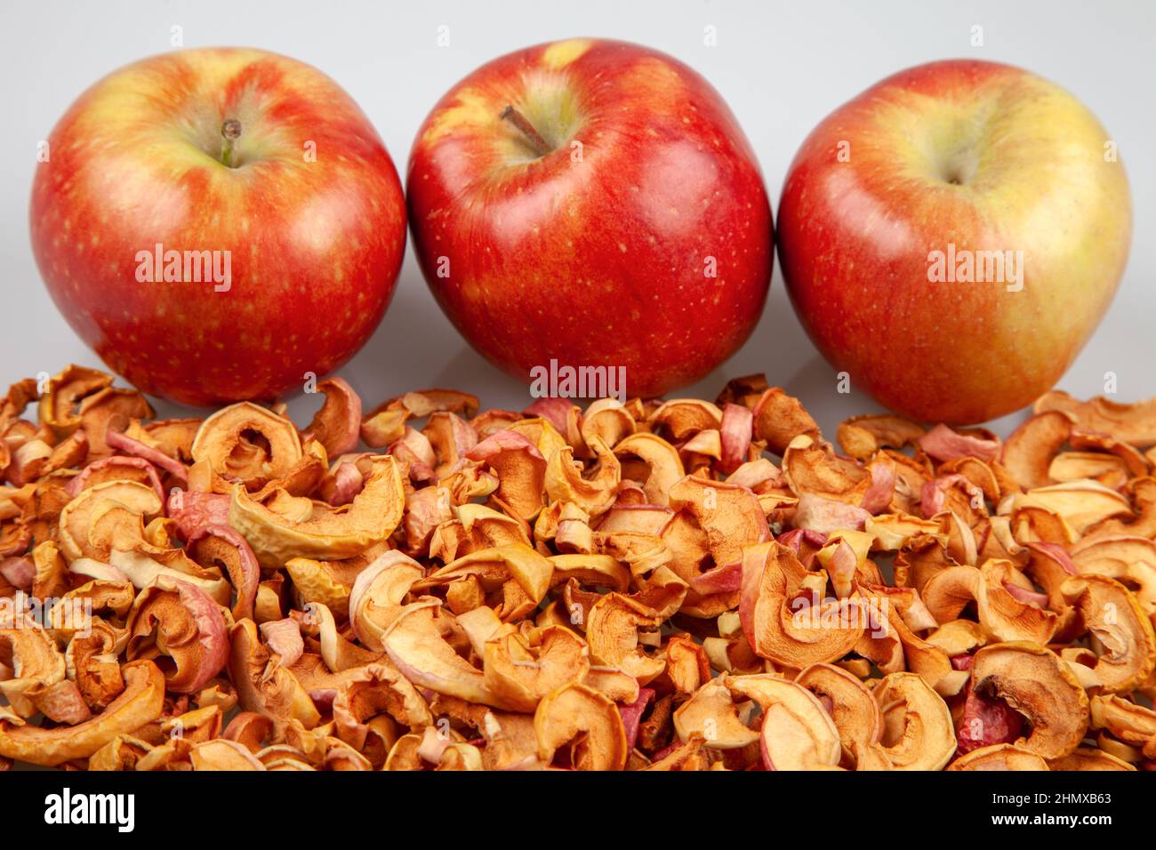 Fresh red apples on dried apple slices Stock Photo