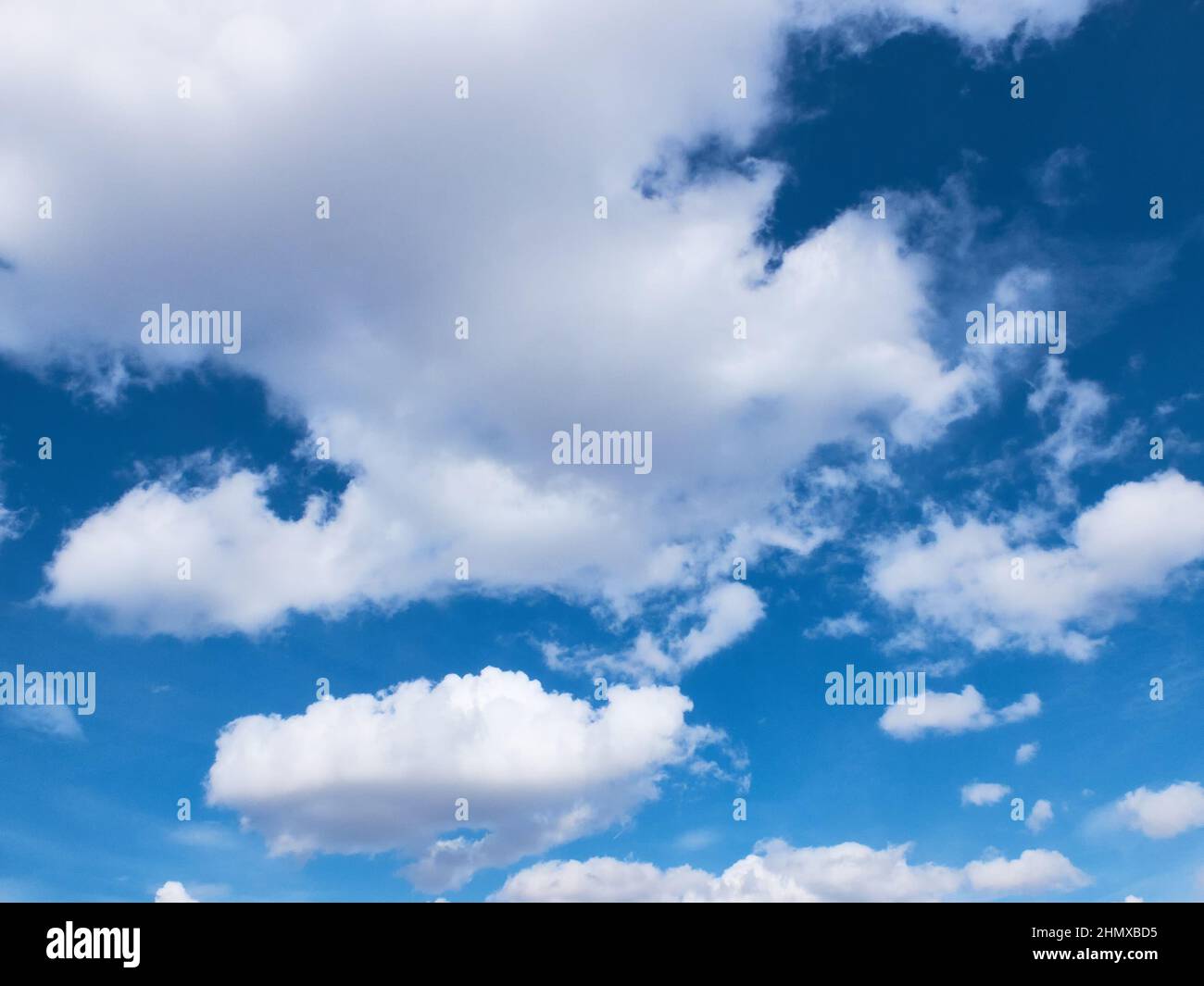 White clouds in a bright blue sky Stock Photo