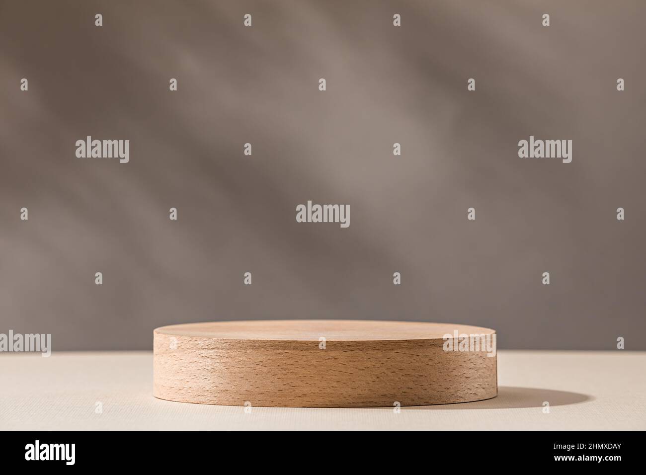 Wooden cylinder podium on a background in warm colors Stock Photo