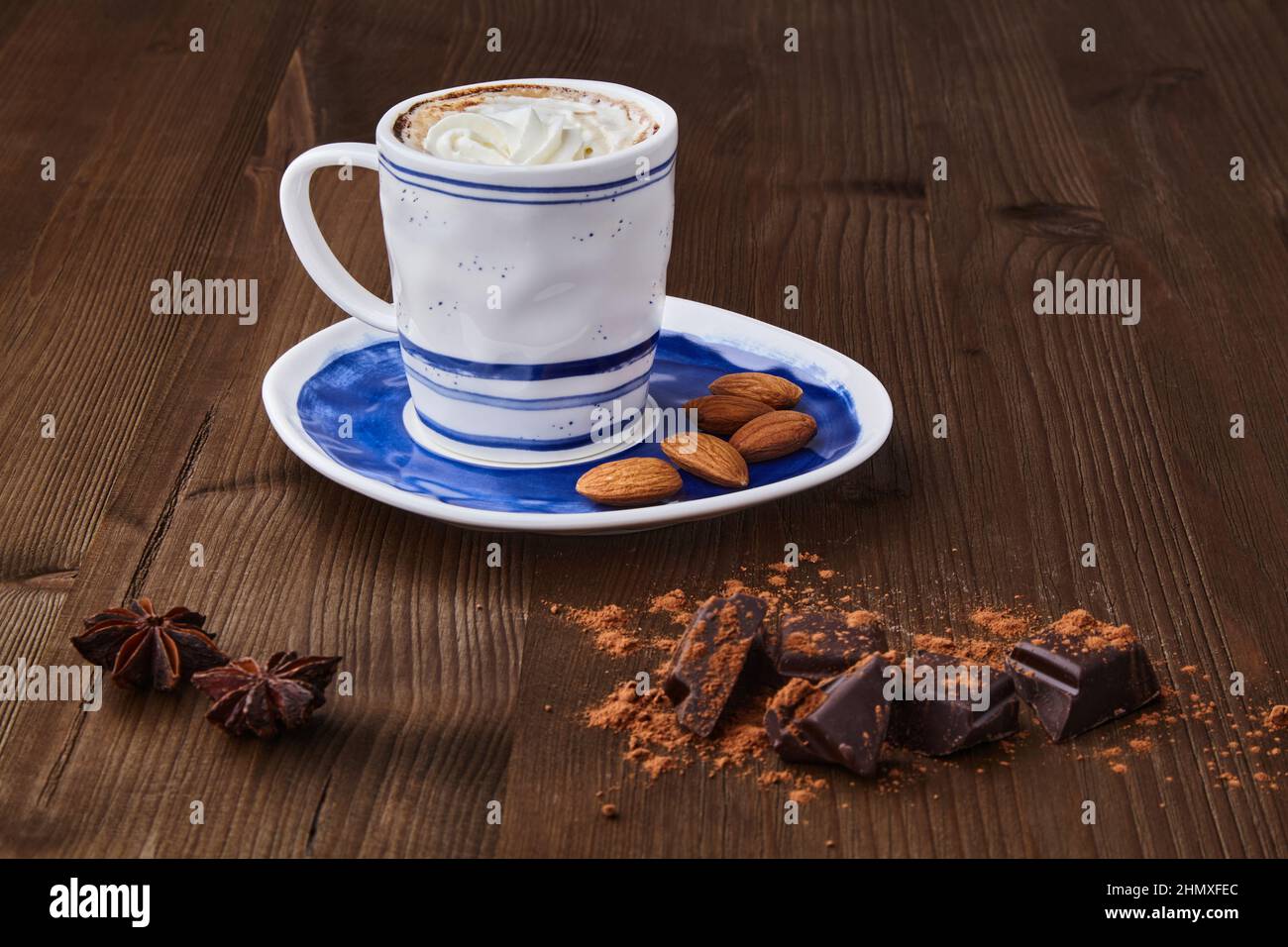 Cup of cappuccino, chopped chocolate, spices and almonds Stock Photo